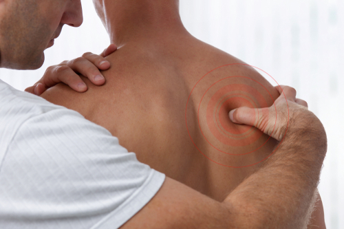 Osteopath examining person with back pain