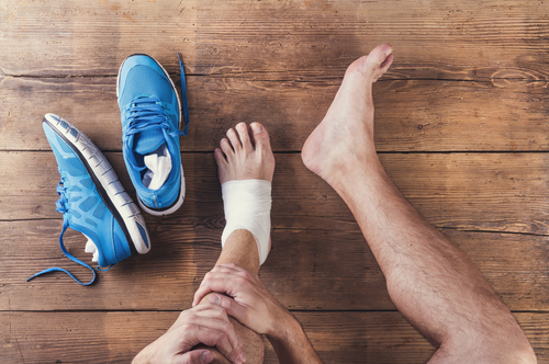 Man with bandaged ankle