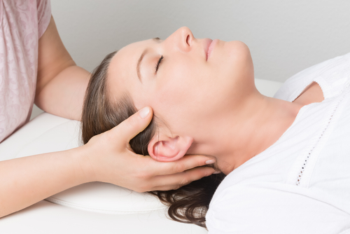Woman having physical therapy for headache