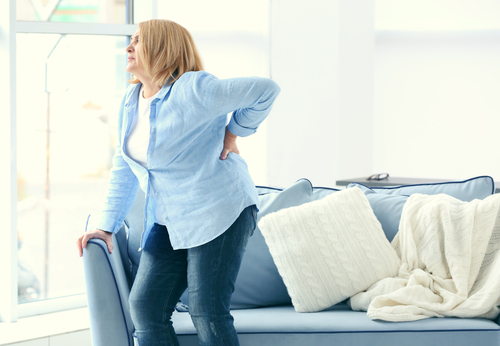 Woman suffering back pain after standing up