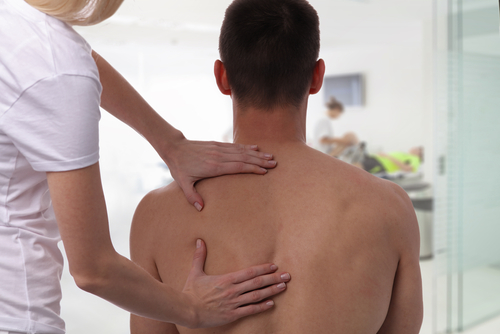 Man receiving osteopathic treatment for back pain
