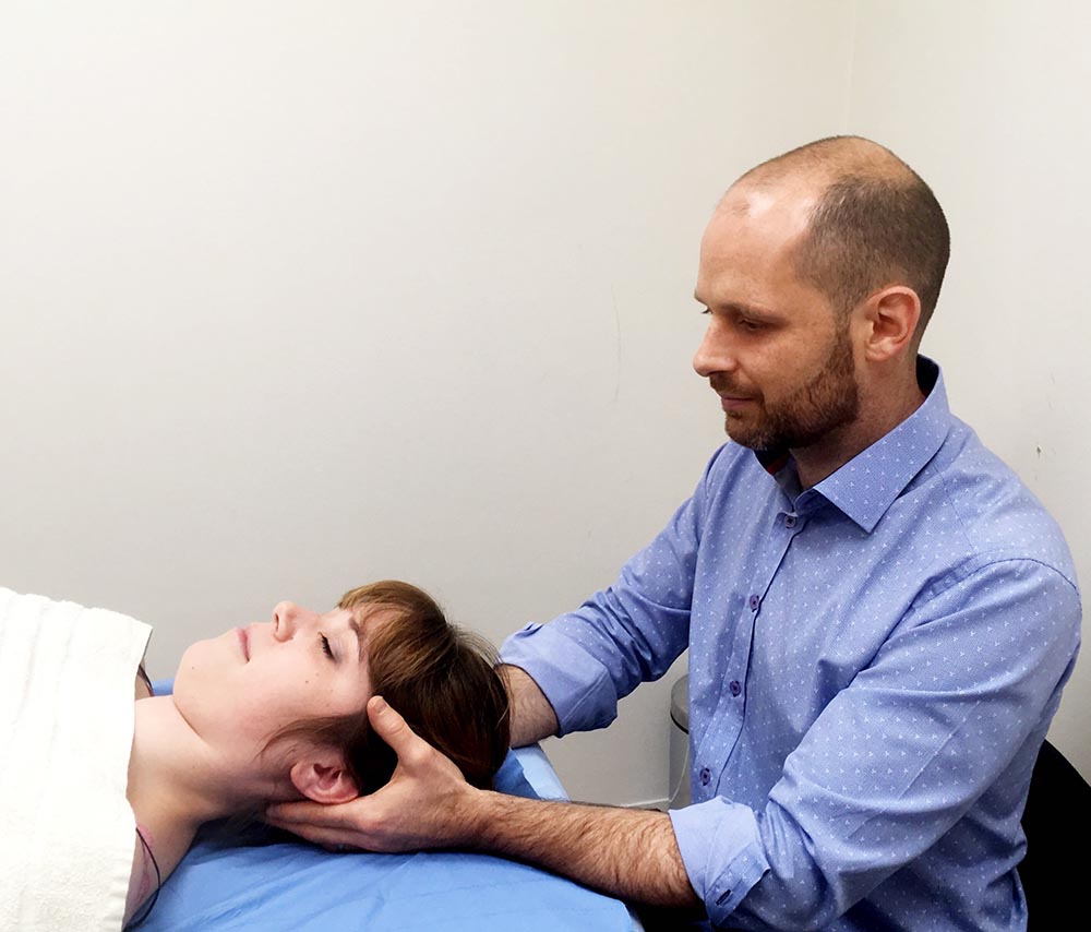Osteopath doing hands-on therapy at Holland Park Osteopathic Practice