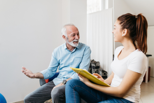 Man discussing with physical therapist