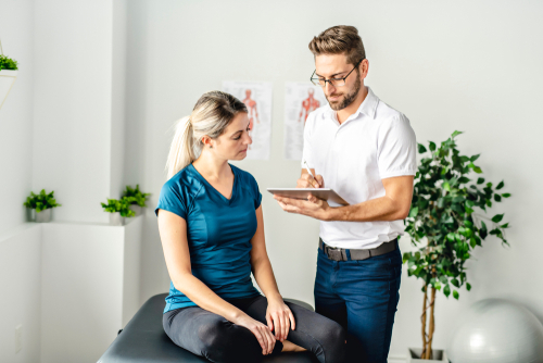 Physical therapist discussing with patient