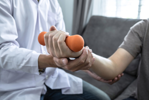 Person doing exercise rehabilitation with dumbell