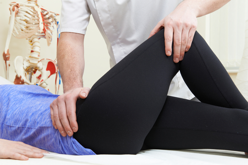 Woman having physical therapy assessment for sciatica