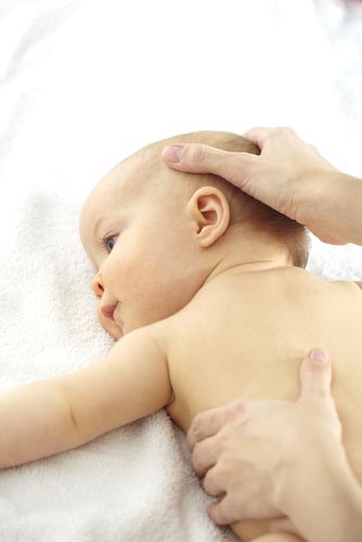 Osteopath performing treatment on a baby