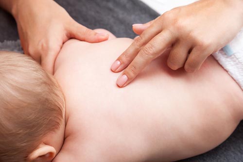 Osteopath performing treatment on baby